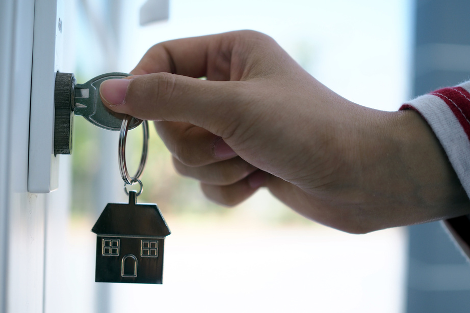 Landlord Opening Door with House Key